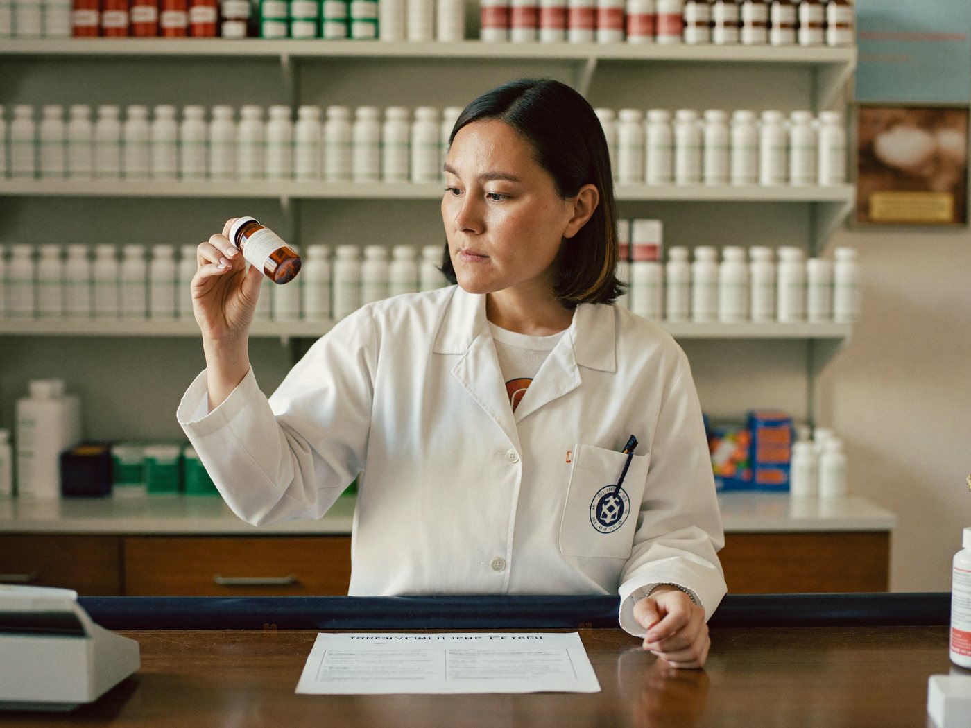 Pharmacy technician working at a pharmacy counter