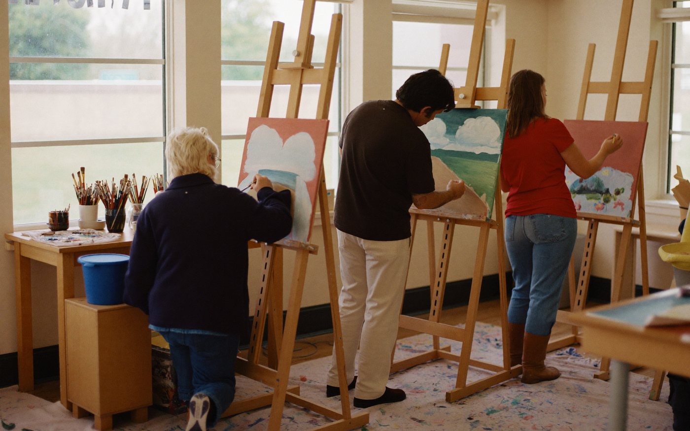 Adult art class painting in a studio